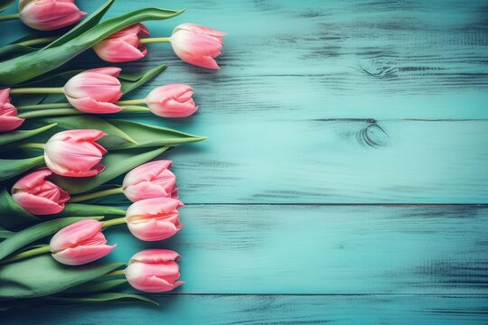 Beautiful frame composition of spring flowers. Bouquet of pink tulips flowers on turquoise blue vintage wooden background. Ai generative.