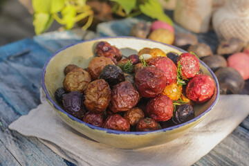 young colored potatoes baked whole in the oven on a plate close-up, appetizing potatoes