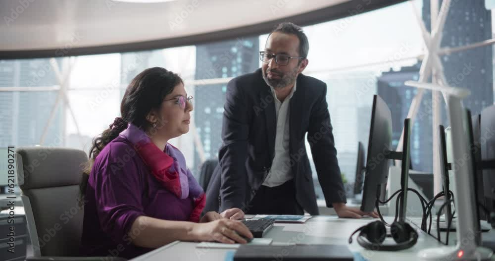 Leinwandbilder financial analyst having a meeting to discuss a business project with a handsome indian team leader.
