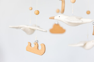 Kids handmade toys above the newborn crib.