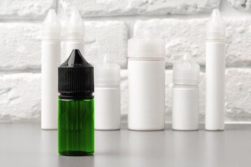 Refill liquid for electronic cigarettes against brick wall background