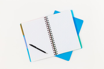 Notepad and pen on a white background, top view.