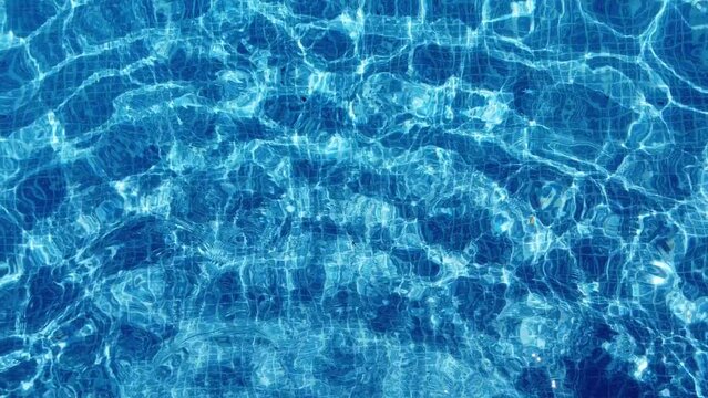 Swimming pool. Upper view of crystal water moving  in the pool. Hot summer holidays. Swimming in the pool.