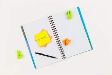 Notepad, pen and paper reminders on a white background.