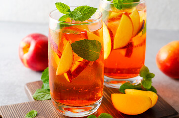 Fototapeta na wymiar Peach Lemonade, Refreshing Drink, Cocktail, Iced Tea, Tasty Peach Cold Summer Drink on Bright Background