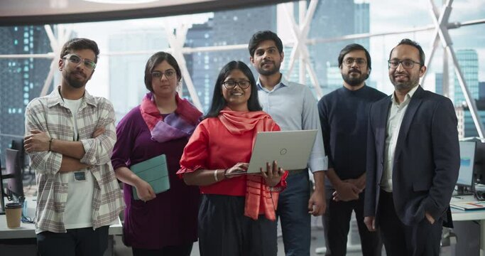Group of Happy Multiethnic Indian Team of Female and Male Managers, Specialists and Business Professionals Posing for Camera and Smiling. Portrait of a Confident South Asian Team Leader Standing First