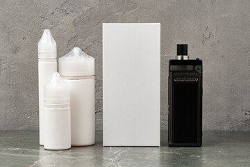 Electronic cigarette with re-fill liquid bottles on gray background