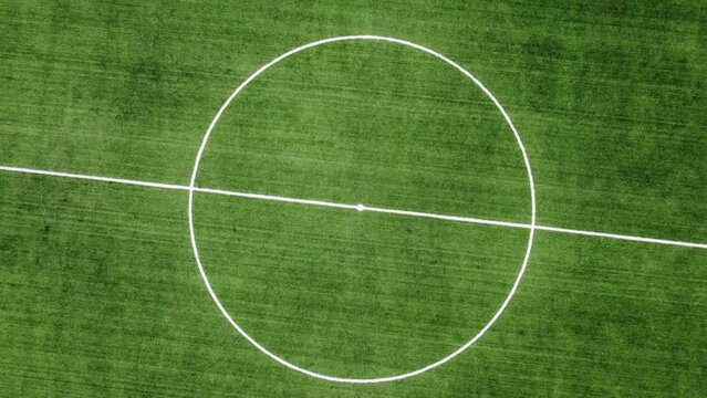aerial top view of empty soccer field with running tracks