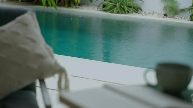Rain falls in a tropical luxury villa with swimming pool in Bali. Close up