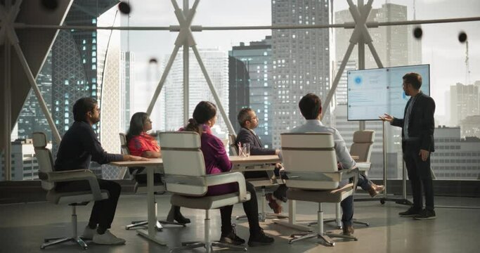 Modern South Asian Business Office Meeting: Confident Indian Manager Uses Interactive Display, Makes Report to a Group of Corporate Partners, Shows Statistics, Growth and Financial Analytics
