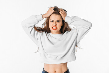Fototapeta premium Image of shocked anxious woman in panic, grabbing her head and worrying, standing frustrated and scared against white background. Stress concept