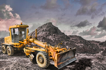 Road grader at a construction site in a quarry. Land surface planning for the construction of a new...