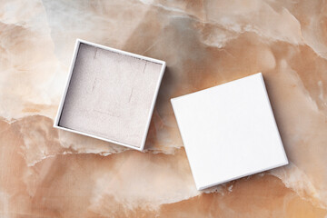 White jewelry box on a white marble background