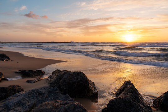 beautiful sunset over the rocky coast in summer
