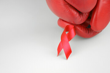 Red ribbon with boxing gloves, wrestling symbol.