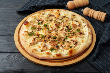 Fresh tasty pizza on black wooden background