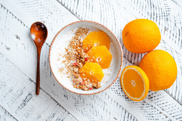 Top view breakfast with oatmeal,orange and Granola