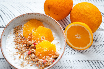 Top view breakfast with oatmeal,orange and Granola