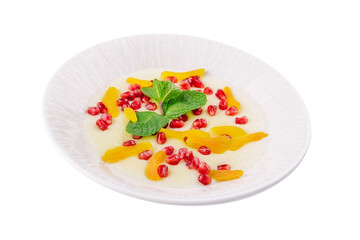 Plate of oatmeal with porridge , dried apricots and pomegranates