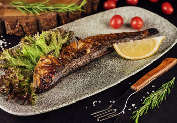 Fish dish - grilled herrings with cherry tomatoes
