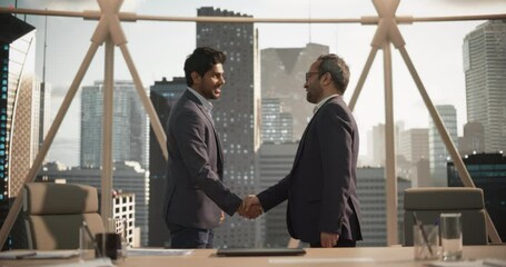 Two Indian Business Partners Meet in Office, Shake Hands. Corporate CEO and Finance Manager Having a Meeting in City Office. Businesspeople Came to Discuss Real Estate Purchase and Marketing Projects