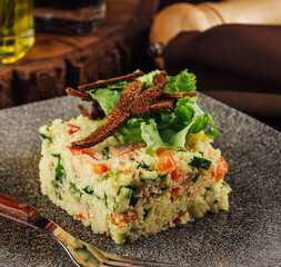 Couscous with vegetables served in plate
