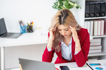 Concept Burnout Syndrome. Asian business Woman feels uncomfortable working. Which is caused by...
