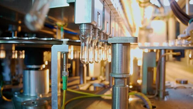 Raw shape of plastic water bottle on conveyor