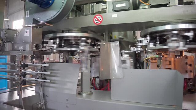 Raw shape of plastic water bottle on conveyor