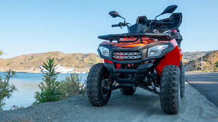 ATV quad bike parked on the shore of Aegean sea on Gokceada island, Canakkale, Turkey