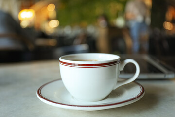A cup of coffee on a table in a cafe