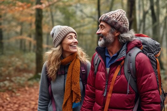 Photorealistic image of a middle aged couple of hikers walk through the forest in rainy weather. They happily communicate during their walk.