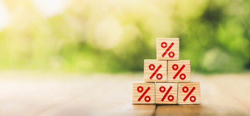 Interest rate financial and mortgage rates concept. Wooden cube block increasing on top with icon...