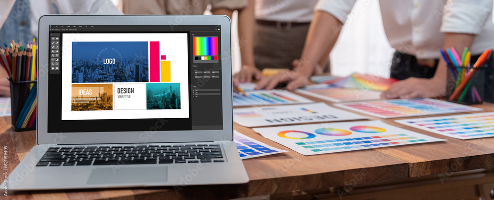 Aufkleber Panorama focus view of laptop display digital art workspace for graphic designer with blurred background of graphic team brainstorm and working on testing color palette for unique design. Scrutinize