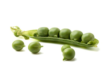 Ripe peas on a white background and half a pea pod.