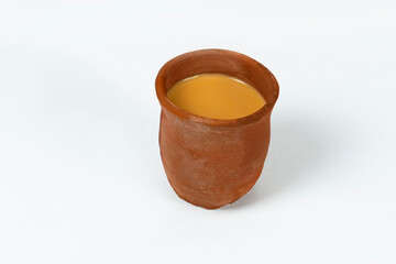 Fresh milk tea or indian karak chai or masala tea in clay cup on white background