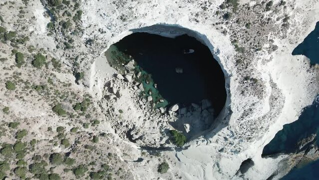 Cauldron-like rock walls of the collapsed cave Sykia, Milos, Cyclades