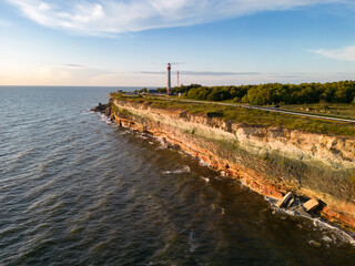 Paldiski peninsula at sunset in summer, an old lighthouse on a cliff in the Baltic Sea.
