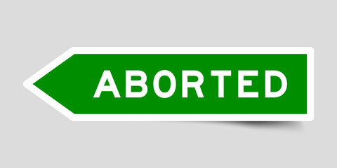 Green color arrow shape sticker label with word aborted on gray background