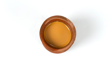 Fresh milk tea or indian karak chai or masala tea in clay cup on white background