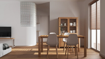 Fototapeta premium Minimal dining and living room in white tones. Wooden table with chairs, glass block wall over kitchen. Cabinets and sofa. Scandinavian modern interior design