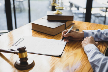 Lawyer working in a law office reading agreement contract documents and signing, Sign the auction...