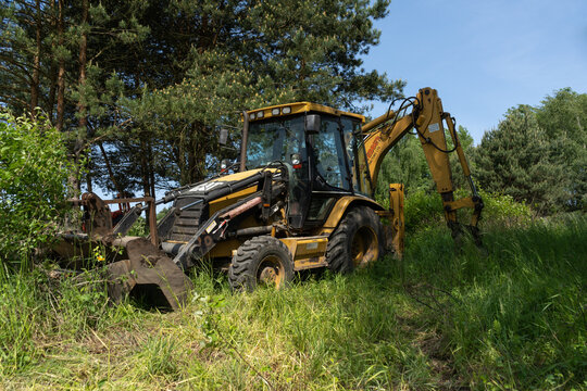 Cat Caterpillar backhoe loader at the construction site. Heavy equipment vehicle, loader excavator or digger on June 3, 2023 in Tenczynek, Poland.