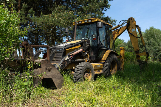 Cat Caterpillar backhoe loader at the construction site. Heavy equipment vehicle, loader excavator or digger on June 3, 2023 in Tenczynek, Poland.