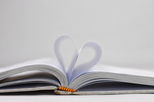 Love of books, reading. An open book with folded pages of books in the shape of a heart. Knowledge Day, Teacher's Day. Library. Reading books.