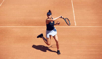 Top view image of young girl, professional tennis player in motion during game, training at open...