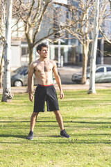 Attractive young man posing in the park after exercising