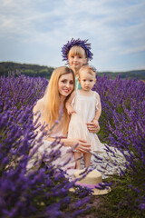 mother with two daughters on a lavender field