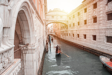 Fototapeta na wymiar Narrow canal in Venice, Italy with boats