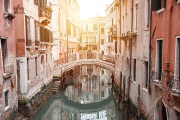 Narrow canal with a bridge in Venice, Italy